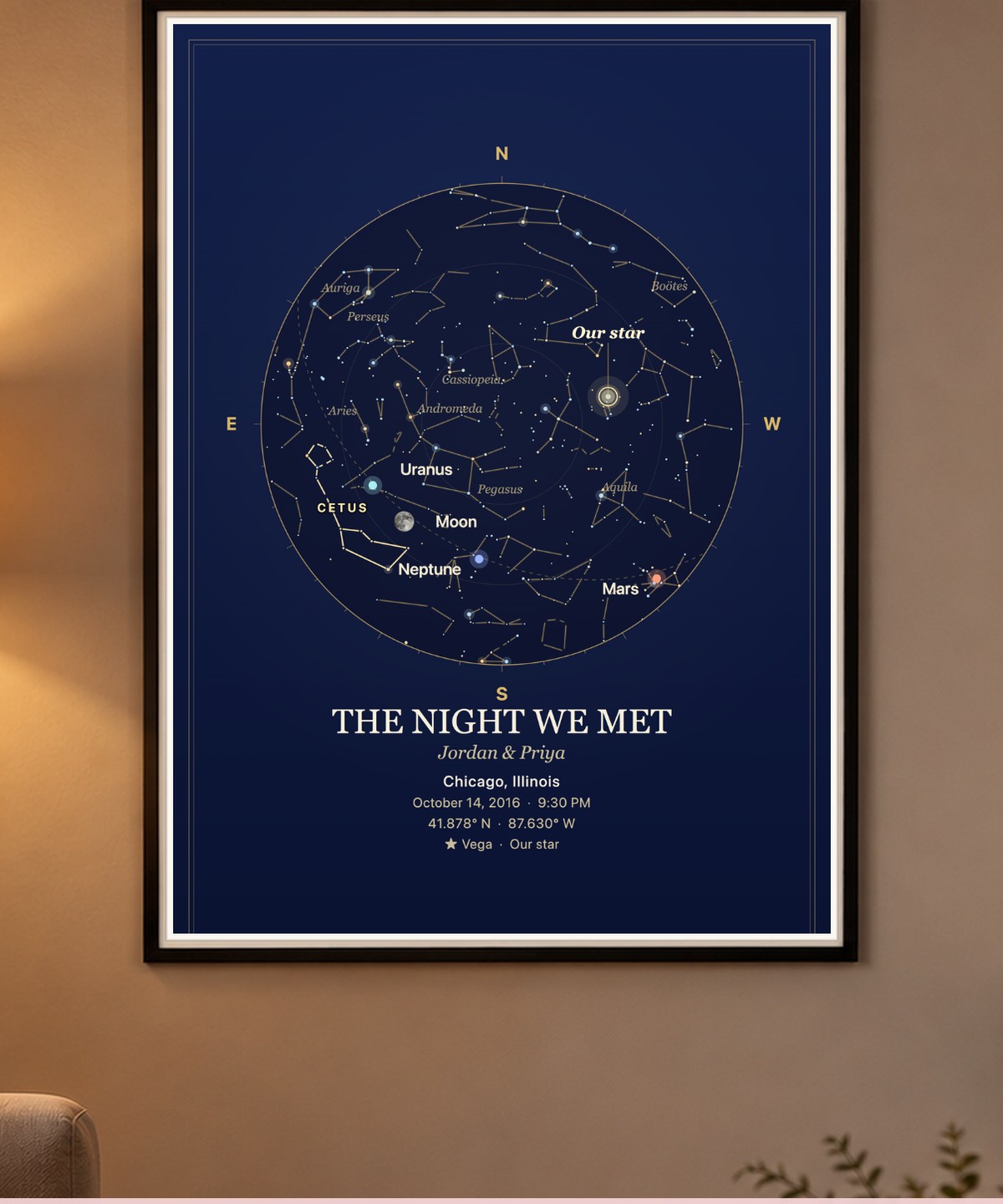 A navy star map titled 'The Night We Met' framed above a made bed with two glowing bedside lamps.